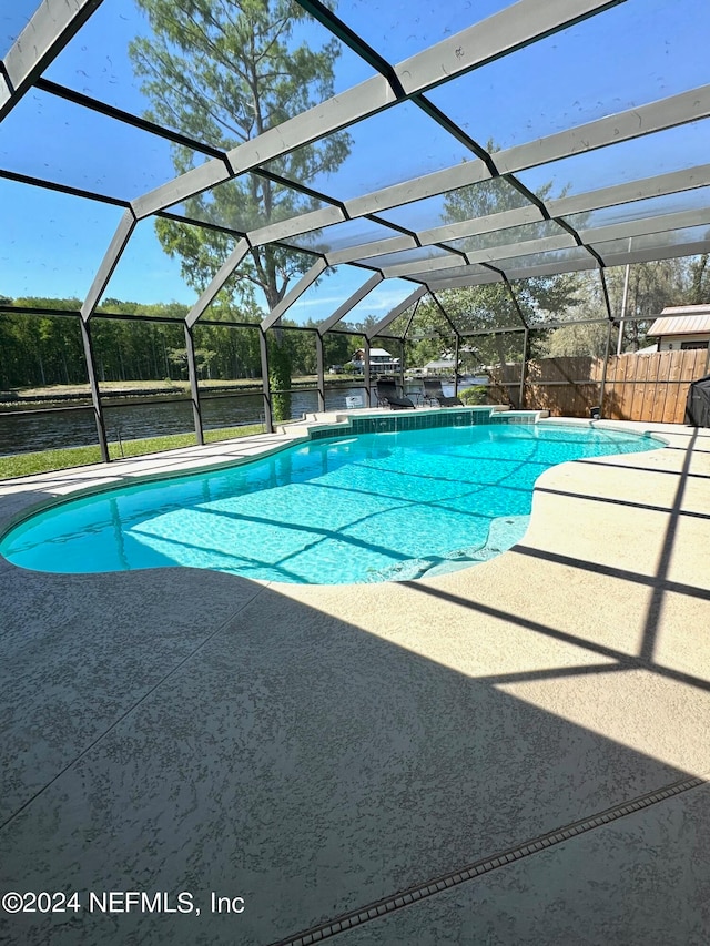 view of pool featuring a water view, a lanai, and a patio area