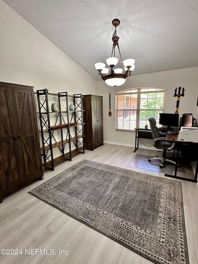 office area featuring a chandelier, lofted ceiling, a textured ceiling, and wood finished floors