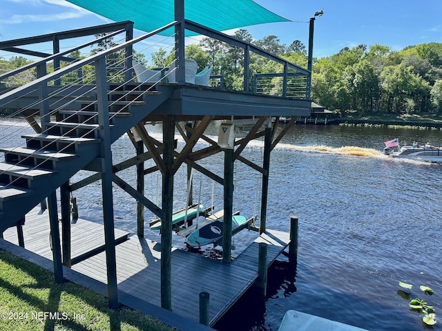 dock area featuring a water view and stairway