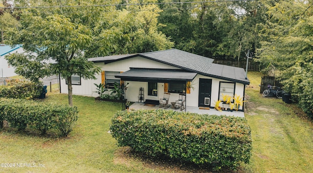 view of front of home featuring a front yard and a patio area