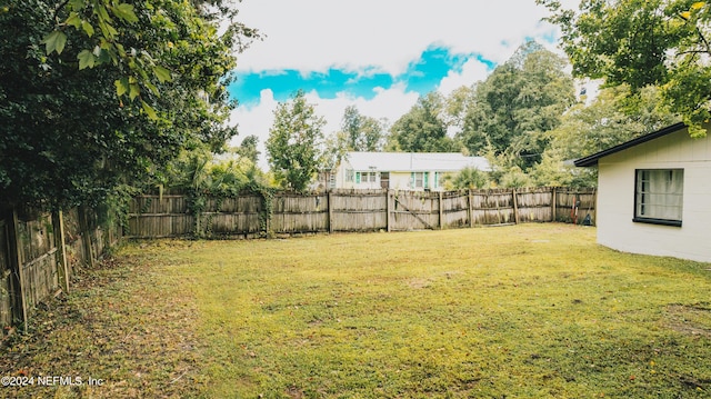 view of yard with a fenced backyard