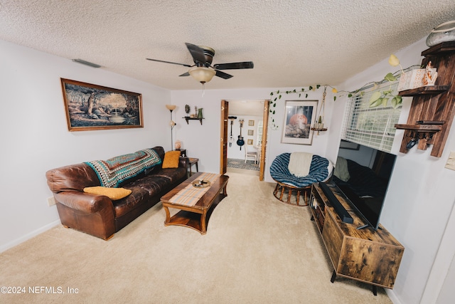 carpeted living room with a textured ceiling and ceiling fan