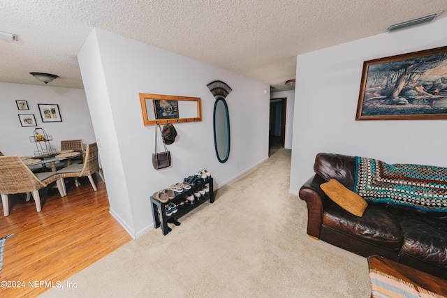 interior space featuring a textured ceiling and light hardwood / wood-style floors