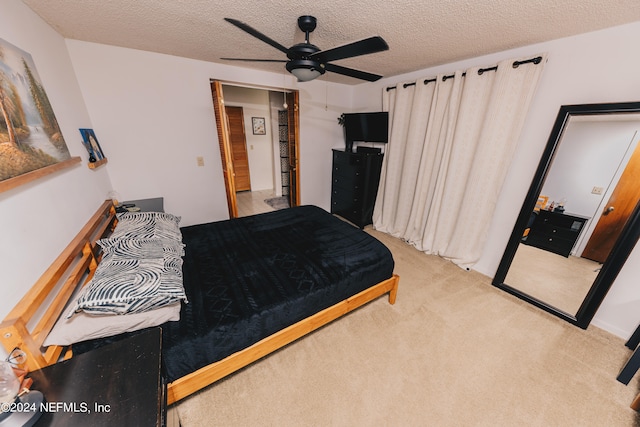 bedroom with light carpet, a textured ceiling, and ceiling fan