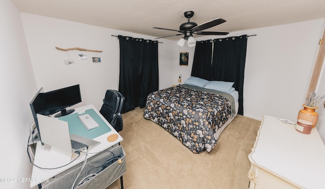 carpeted bedroom featuring a textured ceiling and ceiling fan