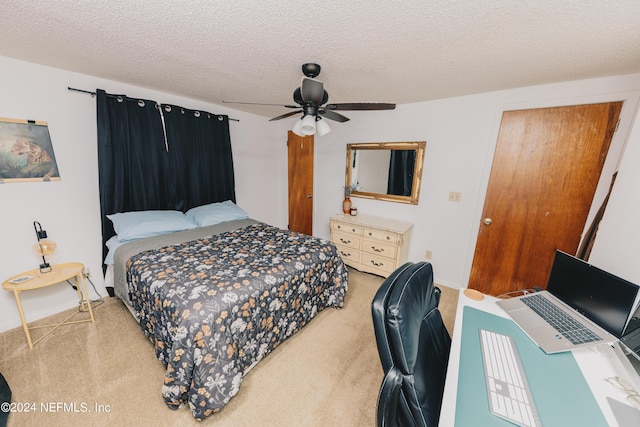 bedroom with carpet, ceiling fan, and a textured ceiling