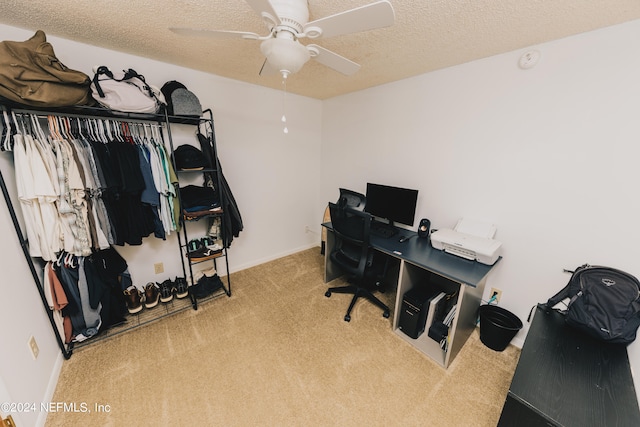 office featuring a textured ceiling, light colored carpet, and ceiling fan