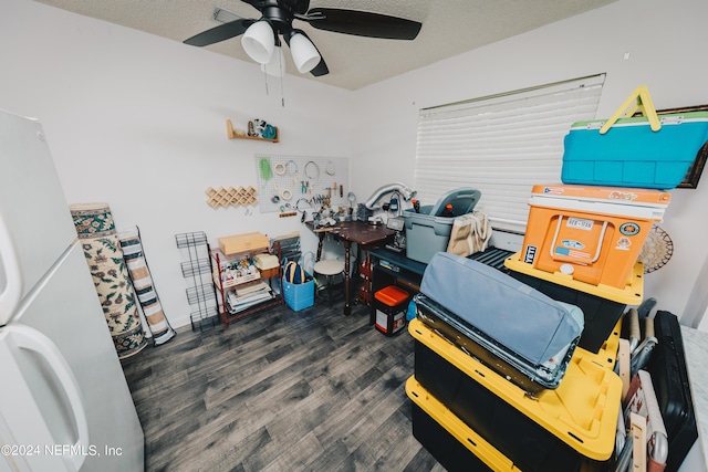 interior space featuring a textured ceiling, a ceiling fan, and wood finished floors