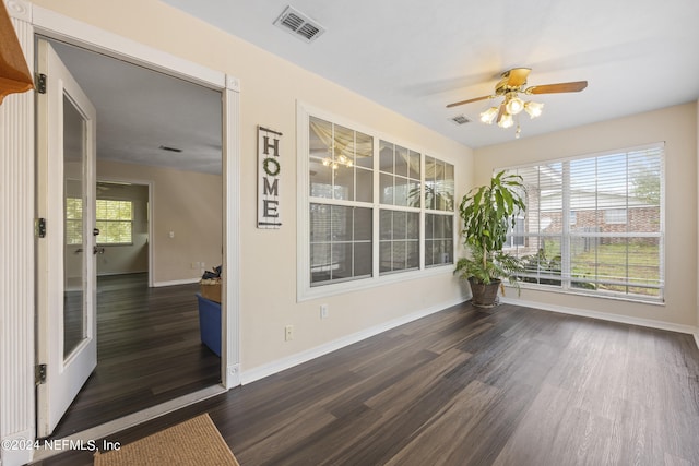 unfurnished room featuring ceiling fan and dark hardwood / wood-style floors