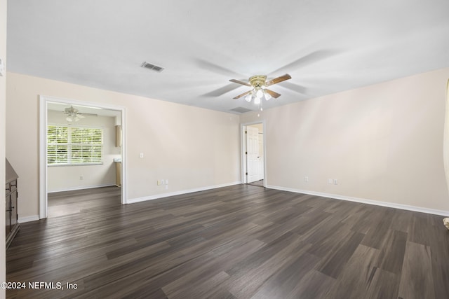 empty room with dark wood-type flooring and ceiling fan