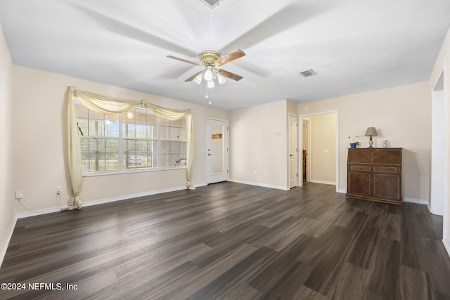 interior space featuring dark wood-type flooring and ceiling fan