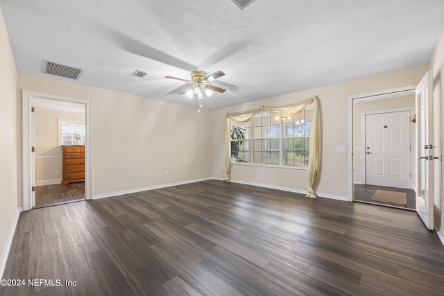 empty room featuring ceiling fan and dark hardwood / wood-style floors