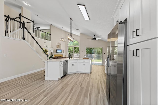 kitchen with light wood-type flooring, appliances with stainless steel finishes, white cabinetry, ceiling fan, and pendant lighting