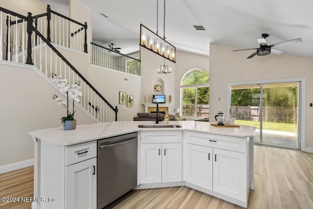 kitchen with dishwasher, sink, ceiling fan with notable chandelier, and white cabinets