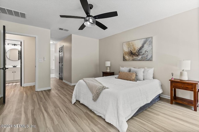 bedroom featuring ceiling fan, connected bathroom, and light hardwood / wood-style floors