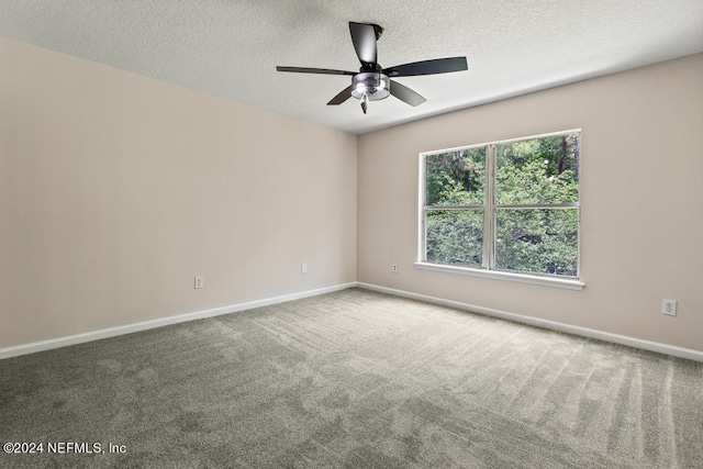 carpeted spare room with a textured ceiling and ceiling fan