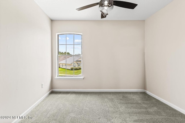 carpeted spare room with ceiling fan