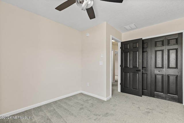 unfurnished bedroom with a closet, ceiling fan, and carpet