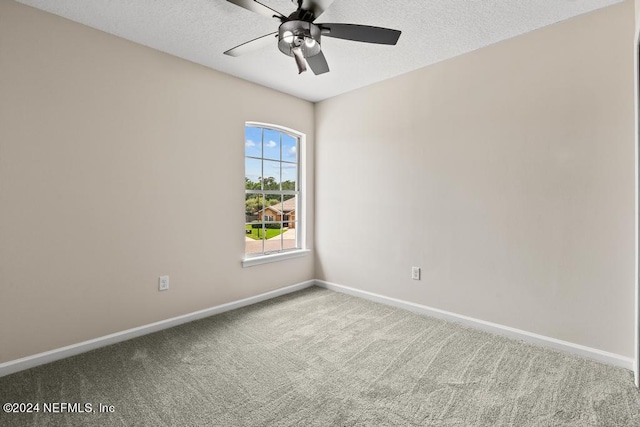 spare room featuring ceiling fan, a textured ceiling, and carpet floors