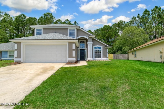 view of front of property featuring a garage and a front yard