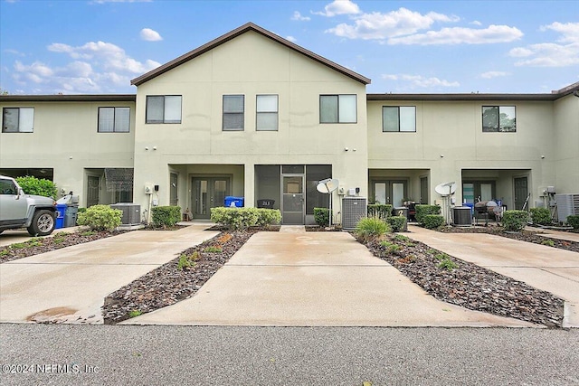 exterior space featuring stucco siding, central air condition unit, and french doors