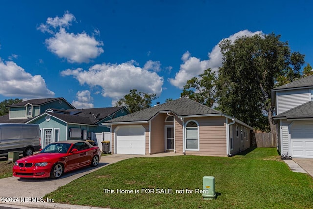 view of front facade with a garage and a front yard