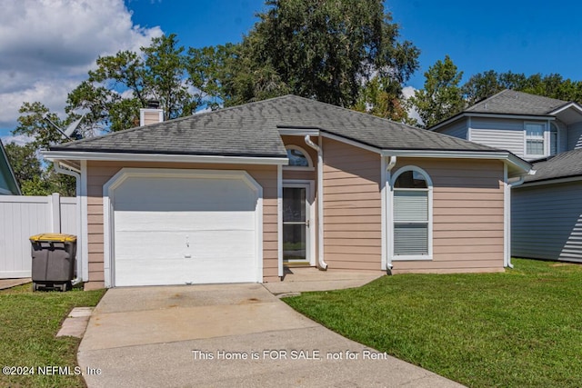 view of front of property featuring a garage and a front yard