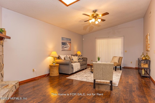 living room featuring vaulted ceiling, a textured ceiling, ceiling fan, and dark hardwood / wood-style flooring