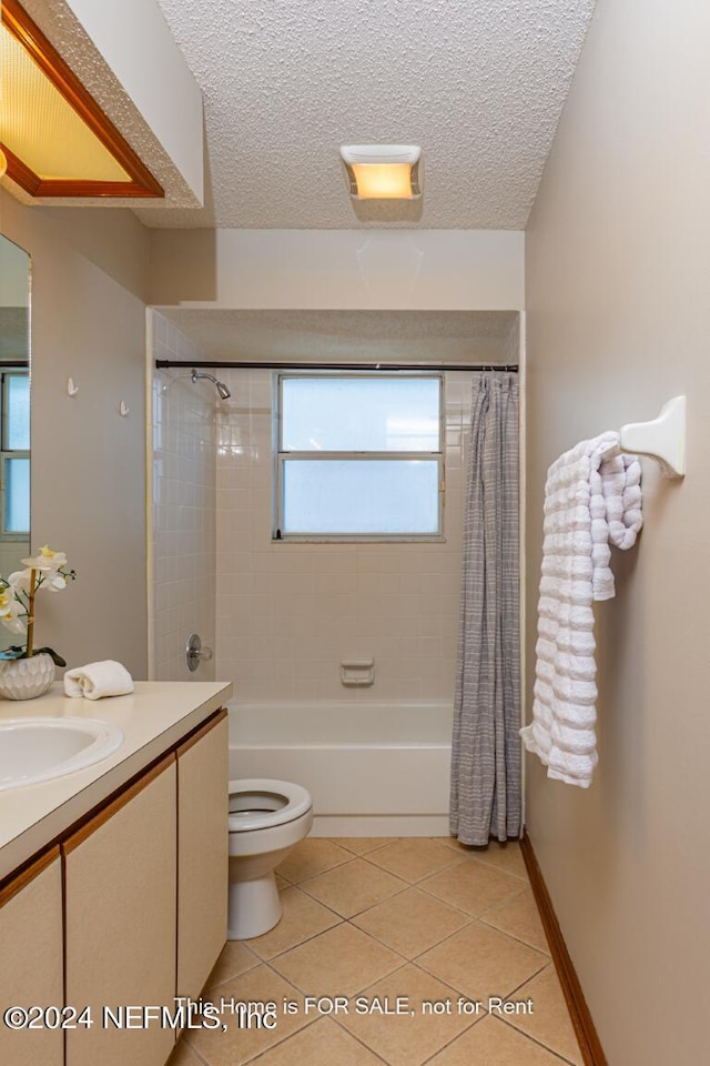 full bathroom with a textured ceiling, vanity, shower / bathtub combination with curtain, tile patterned flooring, and toilet