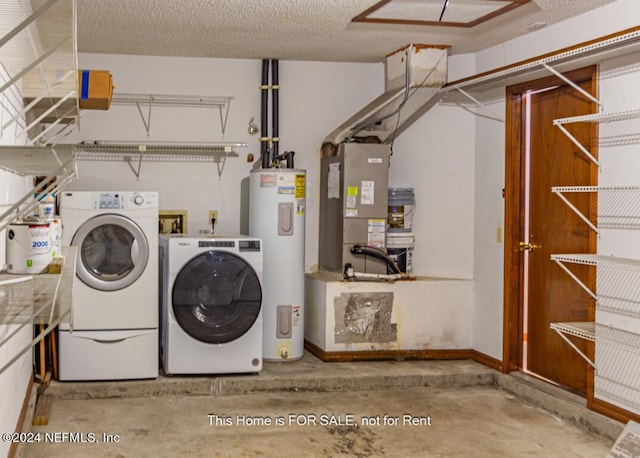 laundry room with heating unit, washing machine and dryer, a textured ceiling, and water heater