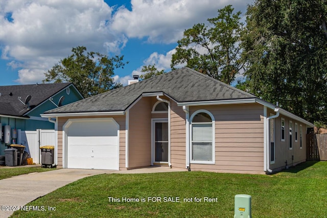 view of front of house featuring a garage and a front lawn