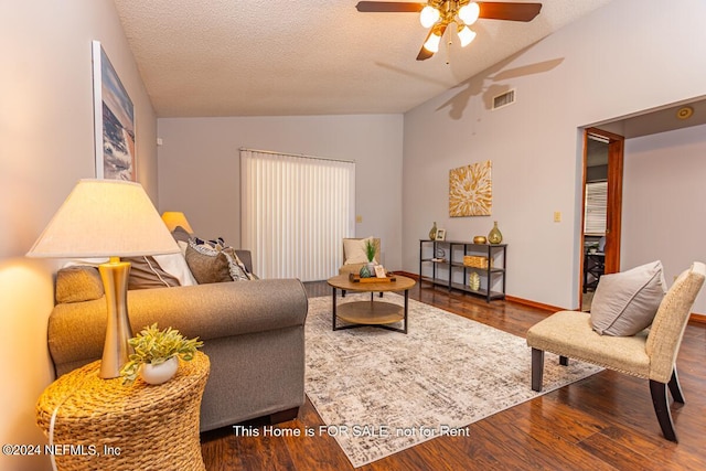 living room featuring hardwood / wood-style floors, a textured ceiling, vaulted ceiling, and ceiling fan