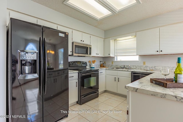 kitchen featuring white cabinets, a textured ceiling, and black appliances