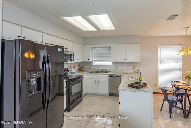 kitchen with white cabinetry, pendant lighting, and black appliances