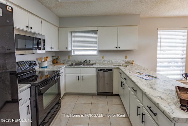 kitchen featuring white cabinets, sink, a textured ceiling, and black appliances