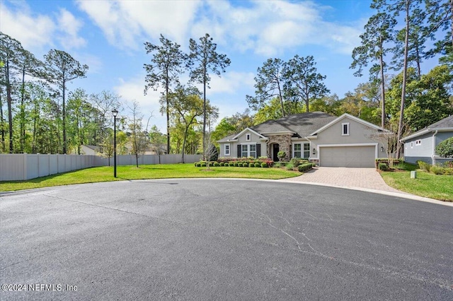 view of front of home with a front yard and a garage