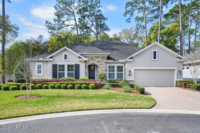 ranch-style home with a front yard and a garage