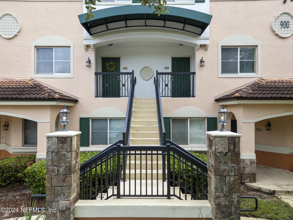 view of exterior entry featuring a balcony