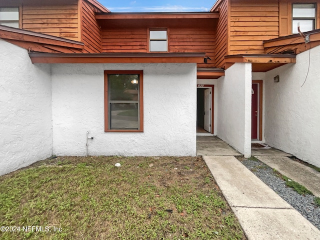 entrance to property with a yard