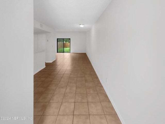 corridor with light tile patterned flooring