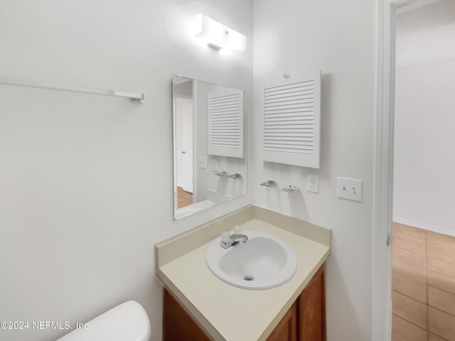 bathroom with vanity and toilet