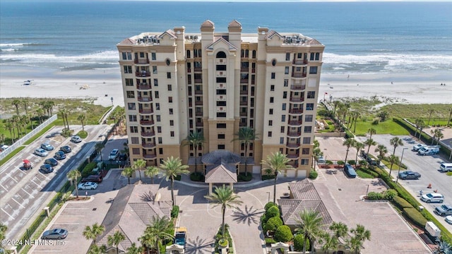 view of building exterior featuring a view of the beach and a water view