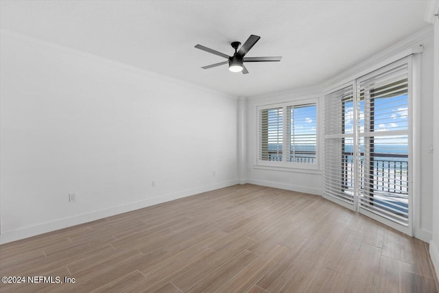 unfurnished room with ornamental molding, light wood-type flooring, and ceiling fan