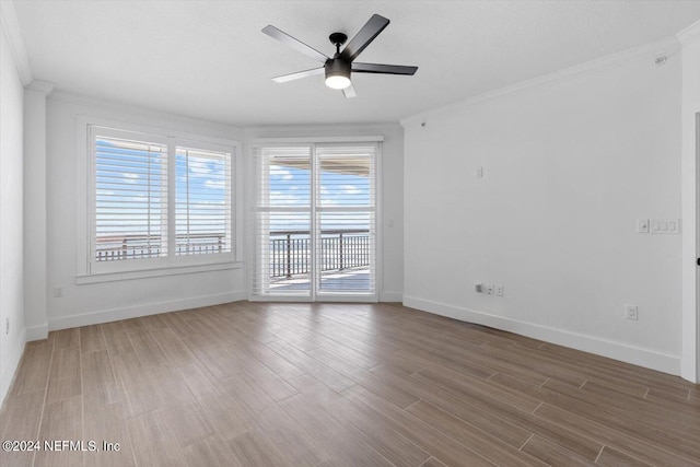 spare room featuring a textured ceiling, ornamental molding, hardwood / wood-style floors, and ceiling fan