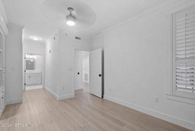 unfurnished bedroom featuring crown molding, ceiling fan, and light hardwood / wood-style flooring