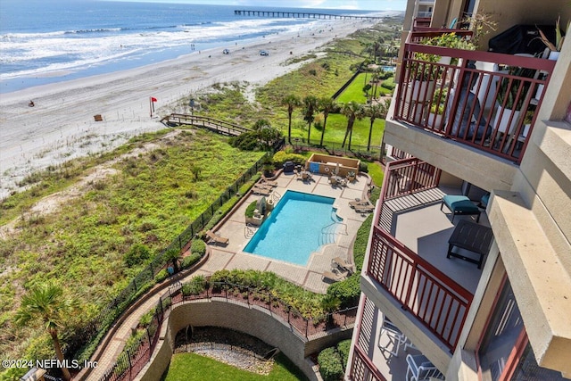 birds eye view of property with a water view and a beach view