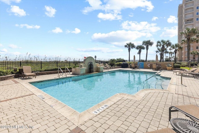 view of swimming pool featuring a patio area