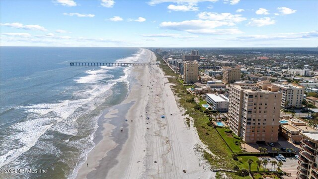 drone / aerial view featuring a view of the beach and a water view