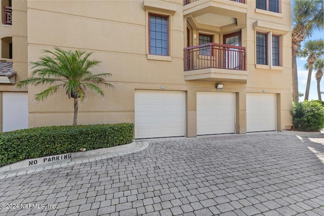 view of front of house with a balcony and a garage