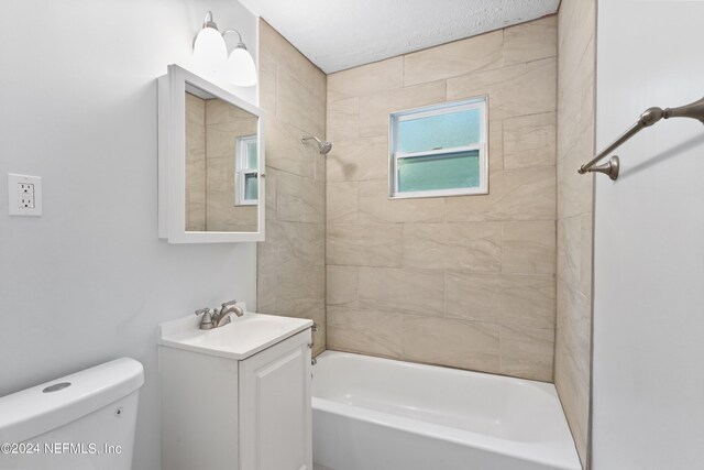 full bathroom with vanity, toilet, and tiled shower / bath